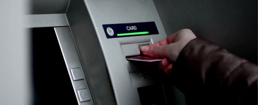 A man withdrawing money from ATM machine